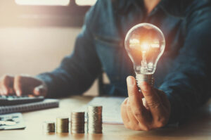 Man learning about commercial energy audit. Holding a light bulb.