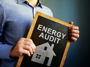 Man holding energy management vs energy audit sign