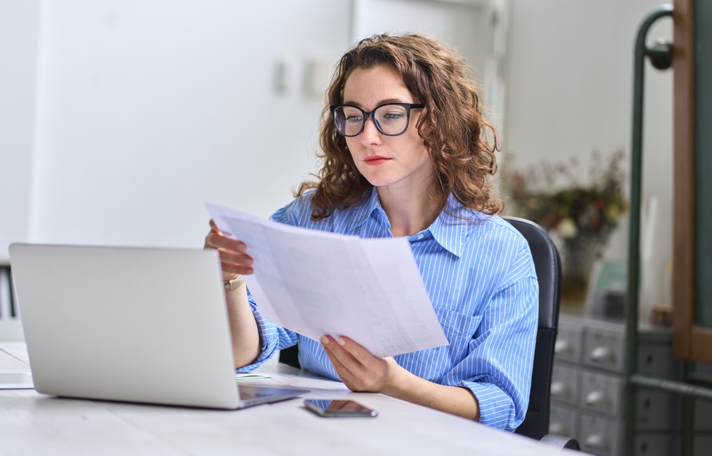 A woman reviewing her utility bill.